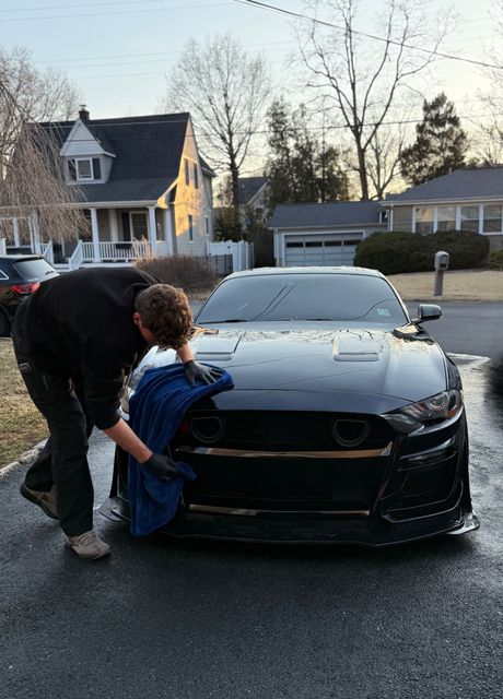 OnPoint drying the exterior of a Mustang at a mobile detailing appointment